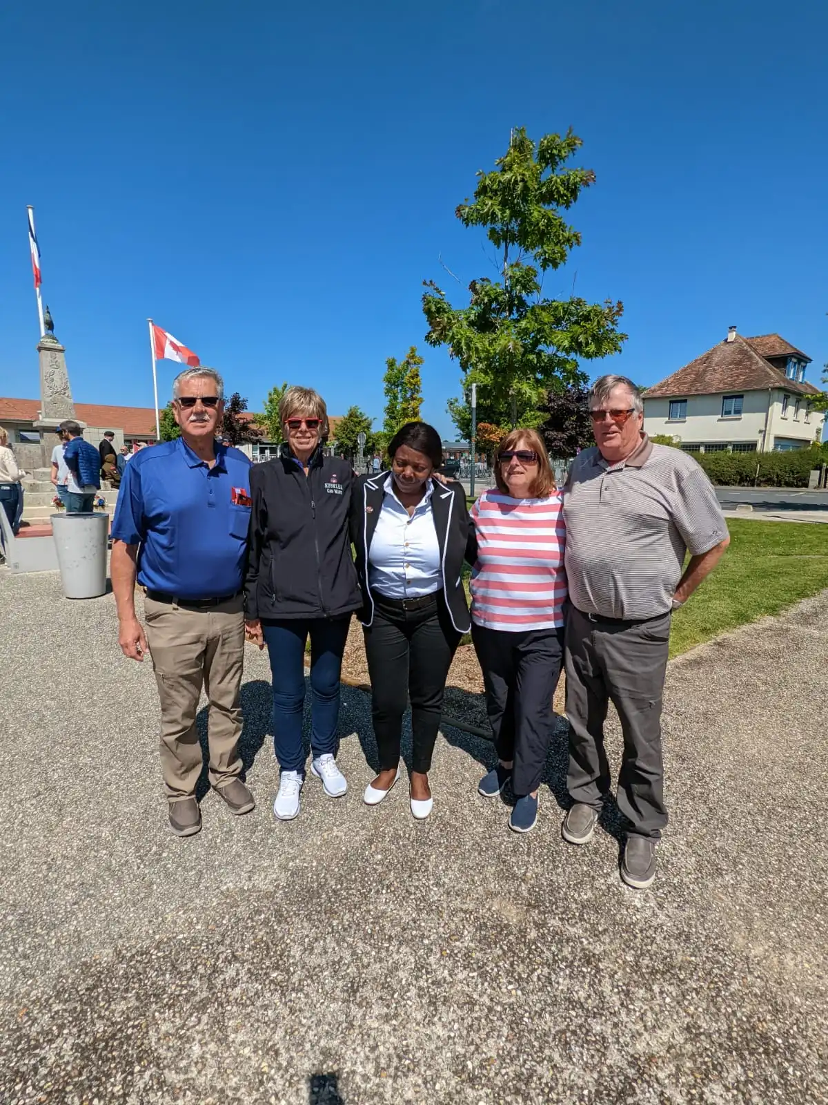 Photo de groupe d'une famille américaine de cinq personnes visitant un site historique en France, illustrant un exemple de transfert touristique pour un service de VTC.